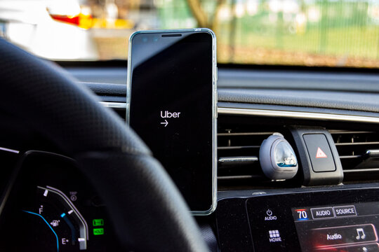 Chicago, Illinois, United States - November 23, 2019 - Shot of a running UBER app with their logo on a phone in a car.