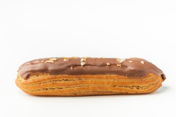 Traditional French pastry. Eclair with custard and chocolate icing isolated on white background. Eclair with cream filling covered with melted milk chocolate