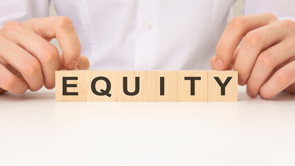 businessman placing the wooden cubes with the word EQUITY. business concept