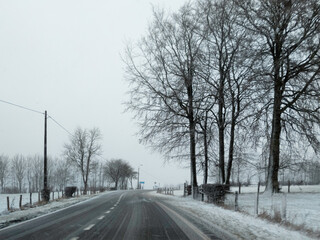 Fototapeta na wymiar A road in the Ardennes on a snowy day