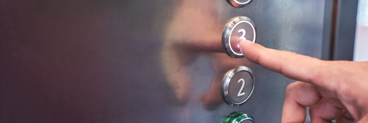 Man hand pointing number 3 button in elevator. Steel interior panel. Change year concept. Waiting new step. Up action. Start claustrophobia moment. Moving click - obrazy, fototapety, plakaty