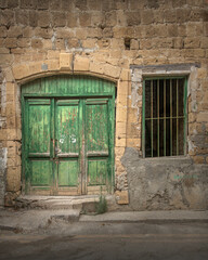 Old historical colorful doors and shutters made of wrought iron and wood. Old historical wooden doors in Cyprus. Doors and shutters of historical stone houses in Nicosia.