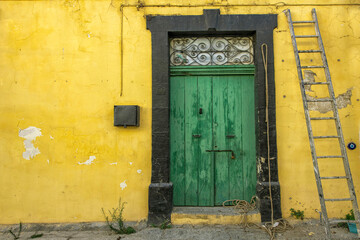 Old historical colorful doors and shutters made of wrought iron and wood. Old historical wooden doors in Cyprus. Doors and shutters of historical stone houses in Nicosia.