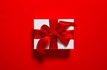 Gift card. Gift box with ribbon bow red  background