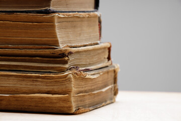 Close-up of several old and antique books arranged in rows. Bookshelf - Selective focus background with shallow depth of field. High quality photo