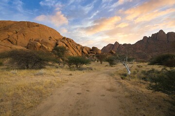 Sunrise in calm morning in Spitzkoppe, panoramic, desert landscape of famous red, granite rocks, Namibia, Africa 