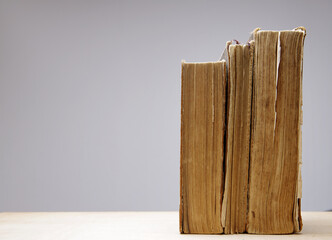  Close-up of several old and antique books arranged in rows. Bookshelf - Selective focus background with shallow depth of field.