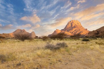 Sunrise in calm morning in Spitzkoppe, panoramic, desert landscape of famous red, granite rocks, Namibia, Africa 