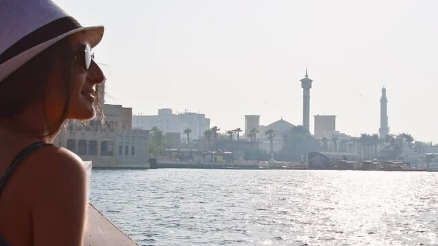 Caucasian woman tourist smile to camera on holiday vacation in Dubai. Tourist on traditional abra boat ride to Dubai creek