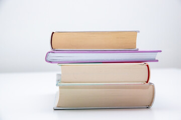 Stack of books on a table with white background