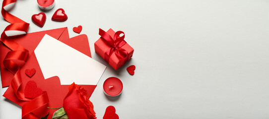 Envelopes, rose, gift, candles and hearts on light background with space for text. Valentine's Day celebration