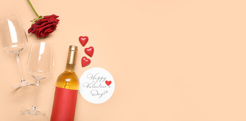Greeting card with text HAPPY VALENTINE'S DAY, bottle of wine, glasses and rose flower on beige background with space for text