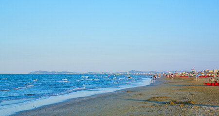 Fototapeta na wymiar Umbrellas and sunbeds on the beach of Rimini in Italy