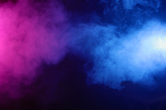 Pink and blue smoke on black background