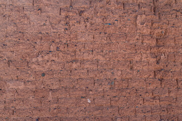 the structure of an old wall made of bricks of clay and stone of red color. background with copy space