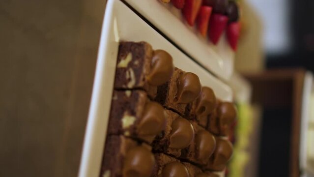 Close up of brownies and small cut fruits decoration of reception at hotel lobby