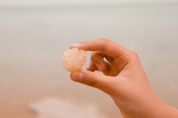Little girl with rock of Dead Sea salt, closeup