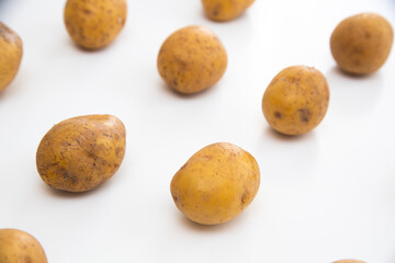 Buch of whole potatoes on white background