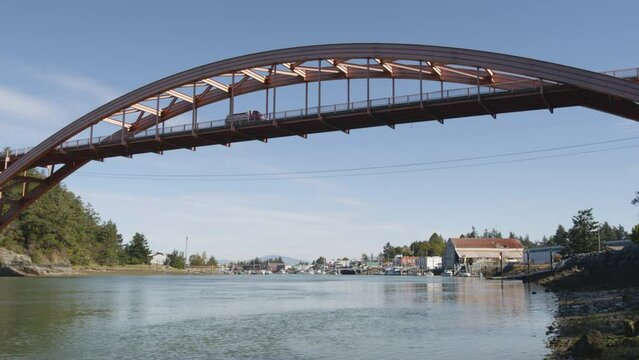 Dump truck crosses Rainbow Bridge in La Conner Washington USA above the Swinomish Channel