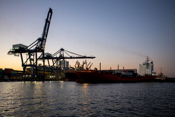 Fototapeta na wymiar Vessel dry cargo on loading, unloading in port. Bulker in port.