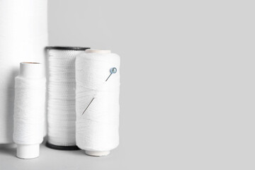 Different thread spools isolated on white background, closeup