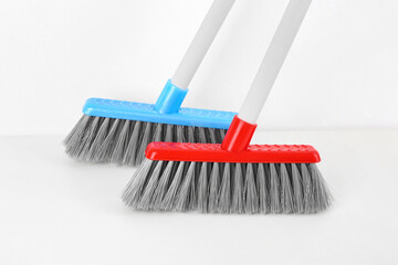 Cleaning brooms isolated on white background, closeup