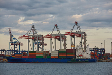 Container ship in port at container terminal. Ships of container ships stand in terminal of port on loading, unloading container.