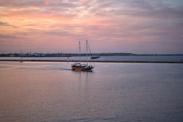 wooden yacht in port. Passenger sailing yacht with a wooden hull leaving the yacht club