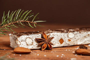 Christmas cookie - almond white chocolate bar with spices, coconut and coffee on wooden background