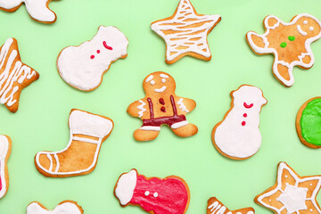 Set of tasty Christmas cookies on green background