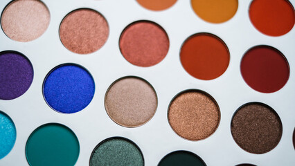 Selective focus of eyeshadow palette with various colors in pearly and matte closeup