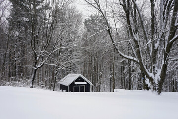 Snow-covered barn at the end of a field after a snowstorm in western Quebec