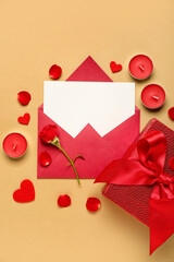 Blank letter with rose, candles, gift and hearts on beige background. Valentine's Day celebration