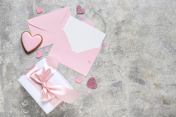 Blank letter with cookie, gift and hearts on grunge background. Valentine's Day celebration