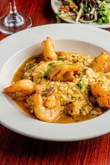 Shrimp and Grits. Grits and old bay seasoned jumbo shrimp topped with spices and micro greens. Classic American Diner Style Breakfast or Brunch menu item. Traditional low country southern staple. 