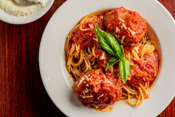 Spaghetti and meatballs. Pasta with homemade meatballs, Parmesan cheese and Italian parsley. Classic American or Italian restaurant favorite. Homemade pasta with tomato sauce, meats and cheeses.