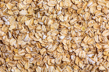 Rolled oat, oat flakes background or texture. Close up. Food concept. Healthy and wholesome food.