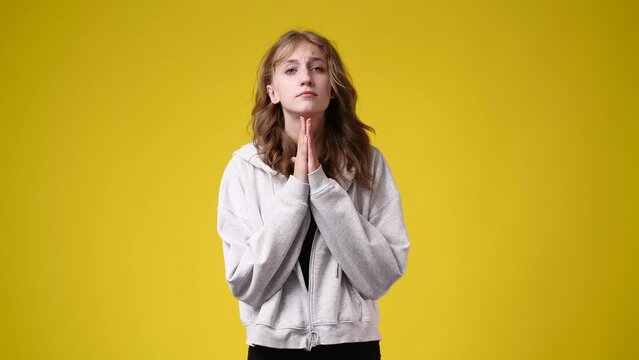 4k video of girl begging please no on yellow background.