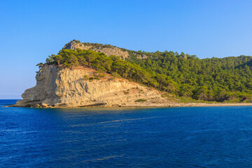 View of the rocky shore from the sea. Mediterranean Sea in Turkey. Popular tourist places. Background