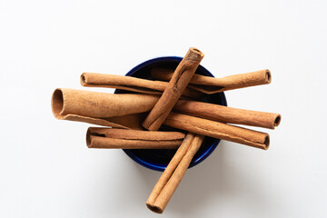 several cinnamon sticks stuck in a round dish