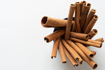 cinnamon sticks in a blue dish (macro lens, particular focus)