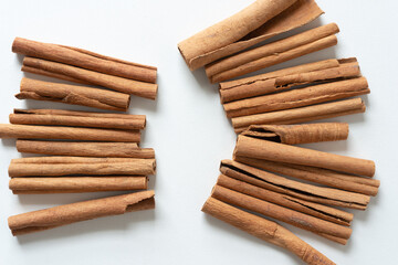 two sets of cinnamon sticks on blank paper