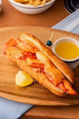 Lobster Roll. Traditional classic American Sandwich. New England classic, fresh Maine Lobster boiled, mixed with mayo, celery, chives served in toasted hero roll with crisp lettuce and drawn butter.