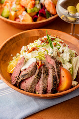 Steak Salad. Kale, chopped mixed greens, grilled chicken, fresh strawberries, cheese, walnuts, almonds mixed with olive oil, balsamic vinegar seasoned w/ salt & pepper. Classic takeout favorite.