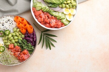 Delicious poke bowls with vegetables, fish and edamame beans on light table, flat lay. Space for text