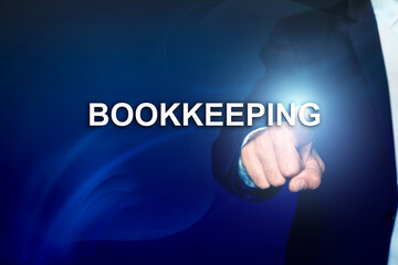 Bookkeeping concept. Businessman pointing at word on dark blue background, closeup