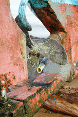 Close-up of the three-blade propeller of a fishing boat on the beach