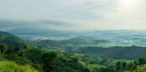 Naklejka premium Beautiful landscape of mountain with view into misty valley in morning time. fog in a mountains valley panorama view.
