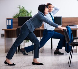Two employees doing sport exercises in the office