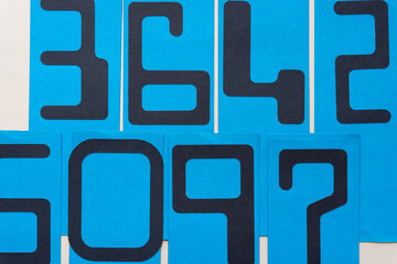 background with large cutout paper numbers on blue cards
